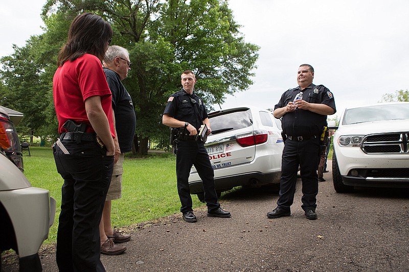 Nashville, Ark., police officers secure the scene of what is believed to be a murder-suicide Friday morning in Nashville.