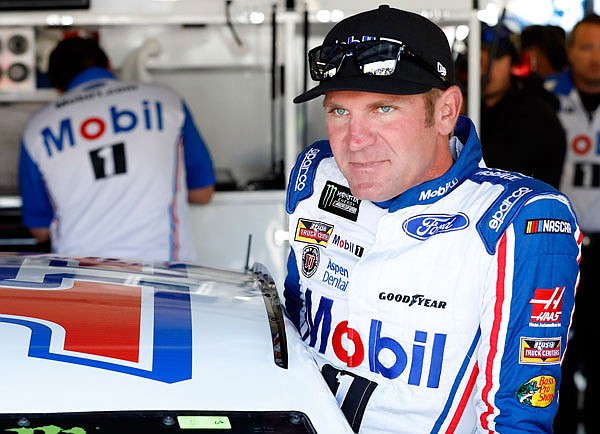 Clint Bowyer climbs into his car during practice Friday for the NASCAR Cup race at Kansas Speedway in Kansas City, Kan.