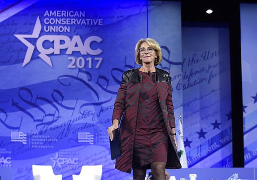 In this Thursday, Feb. 23, 2017 file photo, Education Secretary Betsy DeVos arrives to speak at the Conservative Political Action Conference in Oxon Hill, Md. 