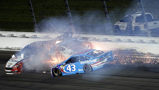 Aric Almirola (43) crashes into Danica Patrick (10) and Joey Logano (22) during the NASCAR Monster Cup auto race at Kansas Speedway in Kansas City, Kan., Saturday, May 13, 2017. 