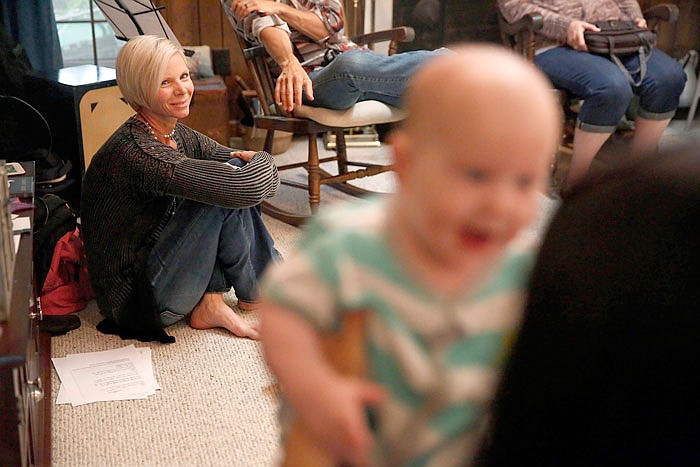 Denise Wilkes, left, looks at baby Noah Burton, sitting on a fellow worshiper's lap, during a church service last year in Birmingham, Alabama. Emma and Noah continued their reign as the most popular baby names last year.