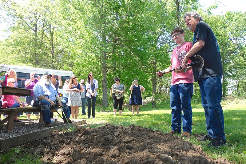 Tanner Bowser, left, son of Mary Alice Bowser, and SERVE, Inc. Executive Director Steve Mallinckrodt break ground Friday on the Mary Alice McCray Bowser Memorial Monarch Habitat.