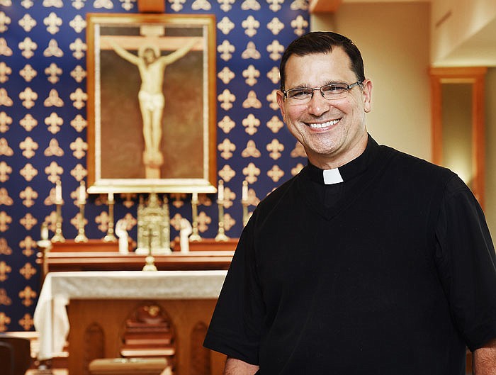 Fr. Tony Viviano poses in the new chapel at Helias High School. 
