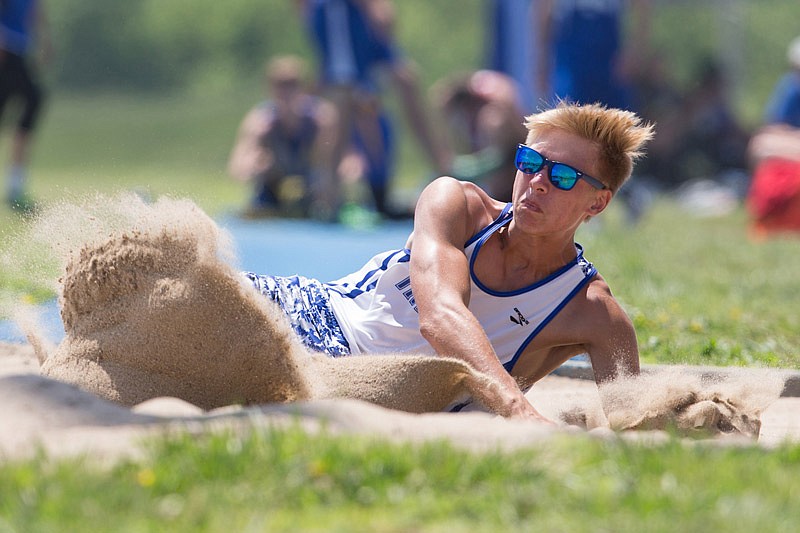 Beau Bryant of Russellville lands in the pit during the long jump competition Saturday, May 13, 2017 in Russellville.