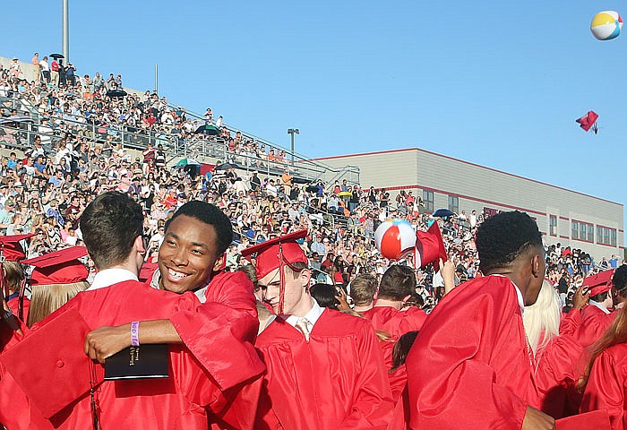 Dante Cartwright congratulates a classmate on graduation after receiving their diplomas at the the Jefferson City High School graduation held at Adkins Stadium in Jefferson City on Sunday, May 14, 2017. 