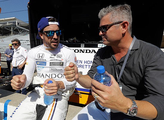 Fernando Alonso (left) talks with Gil de Ferran during Monday's practice session at Indianapolis Motor Speedway in Indianapolis.