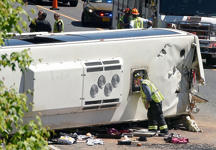 Firefighters respond to an overturned bus on I-95 southbound Monday in Havre de Grace, Maryland.
