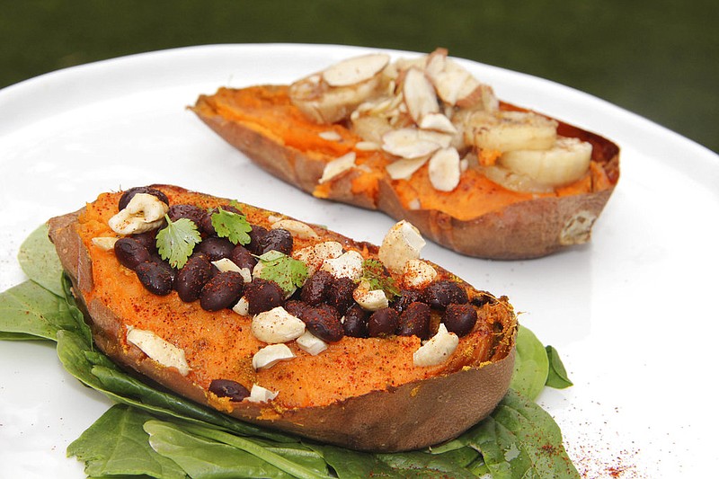 This May 5, 2017 photo shows two halves of a sweet potato prepared with savory and sweet toppings in Coronado, Calif. This dish is from a recipe by Melissa d'Arabian.