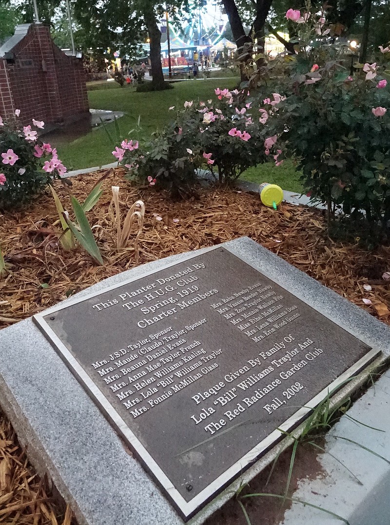 The H.U.G. memorial plaque is in Hughes Spring's Spring Park. H.U.G. stood for Hughes Useful Girls and goes back to its creation in 1919. In 2002, this marker was added to the flower planter box H.U.G. members gave to the park.