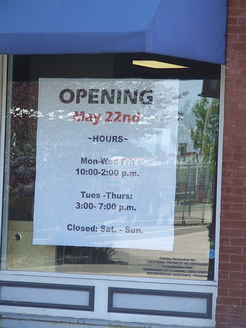 A sign in the door indicates The Wood Place Library will open Monday, May 22, 2017.
