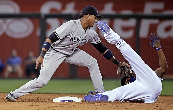 Jorge Soler of the Royals is tagged out at second by Starlin Castro of the Yankees after trying to stretch a single into a double during the fifth inning Tuesday night at Kauffman Stadium.