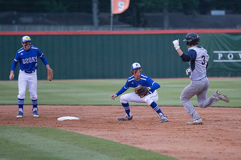 Hooks second baseman Connor Price makes the tag on New Diana's Landon Dorman in Wednesday's Region II-3A quarterfinal game at Texas High in Texarkana.