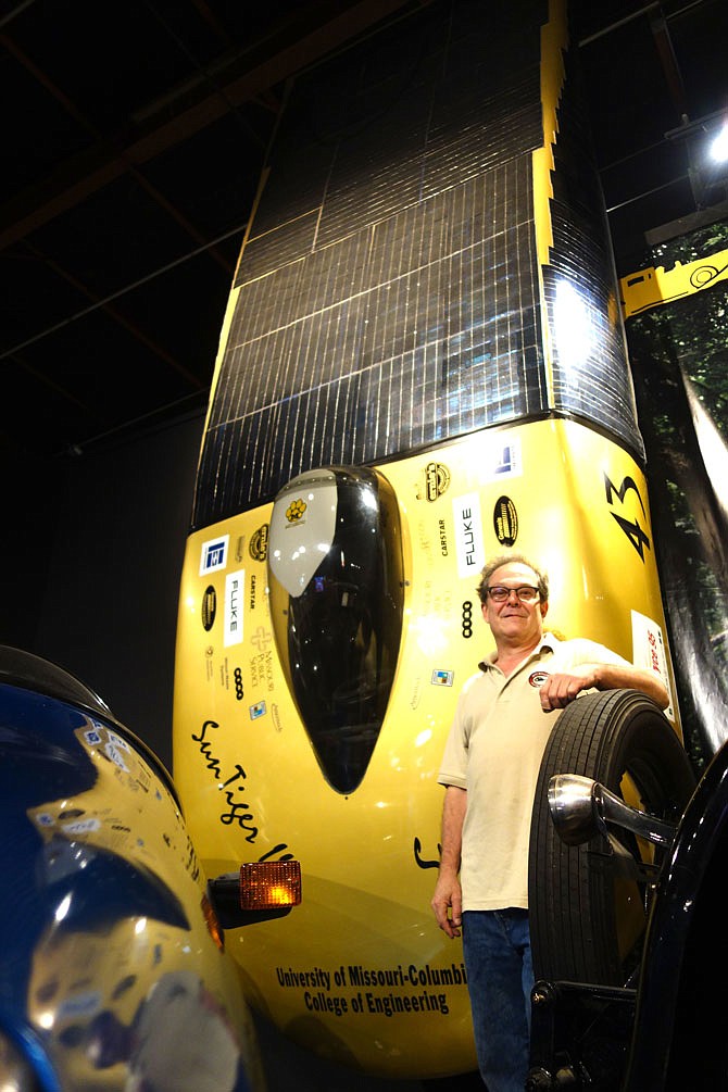 Helen Wilbers/FULTON SUN
Tom Jones, general manager of Auto World Museum in Fulton, stands in front of the "sun car," a solar-powered vehicle created at the University of Missouri.