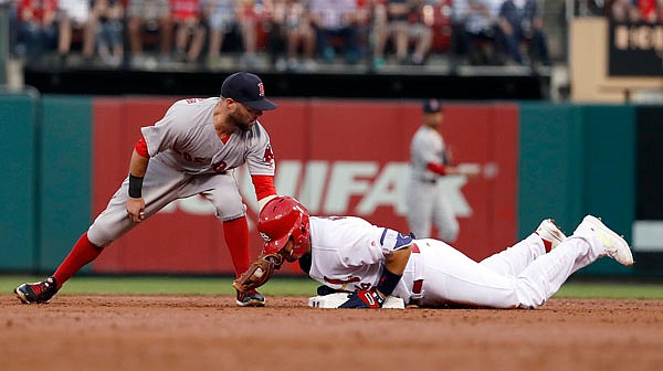 Yadier Molina of the Cardinals is safe at second for a double ahead of the tag from Red Sox second baseman Dustin Pedroia during the second inning of Wednesday night's game at Busch Stadium in St. Louis. 