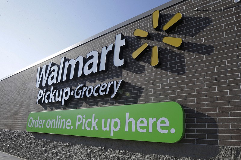 In this Thursday, June 4, 2015, file photo, a sign is displayed at a Wal-Mart pickup grocery site in Bentonville, Ark.