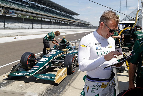 Ed Carpenter looks over data on a tablet during a practice session Wednesday for the Indy 500 at Indianapolis Motor Speedway in Indianapolis.