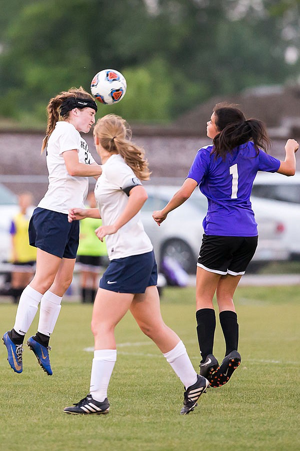 Olivia Farrow of Helias uses a header to pass during the second half of Wednesday's Class 3 District 13 championship game against Camdenton at the 179 Soccer Park.