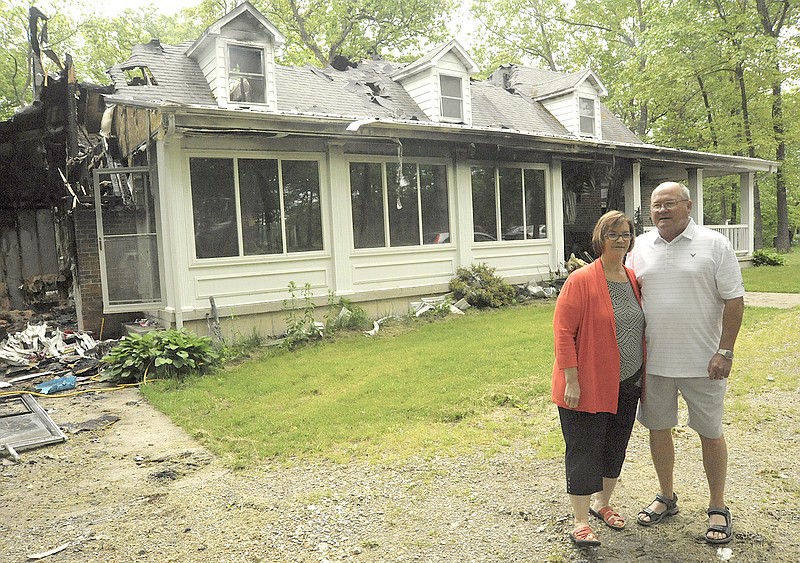 Craig and Linda Rodick stand in front of their home of 34 years that was lost to fire in April.