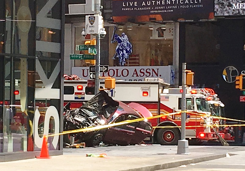A smashed car sits on the corner of Broadway and 45th Street in New York's Times Square after driving through a crowd of pedestrians Thursday, May 18, 2017.
