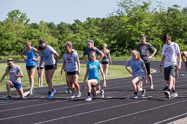 State qualifiers for the Calvary Lutheran Lions and Lady Lions stretch out before practice earlier this week at Thomas Jefferson Middle School. The Lions and Lady Lions will participate in the Class 1 state championships starting today at Adkins Stadium.