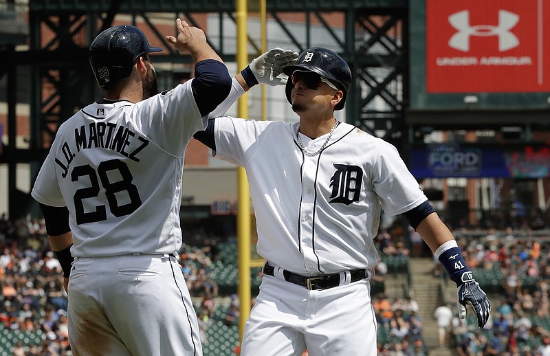 Detroit Tigers designated hitter Victor Martinez, right, is congratulated by J.D. Martinez after reaching home plate on a two-run home run during the fifth inning of a baseball game against the Baltimore Orioles, Thursday, May 18, 2017, in Detroit.