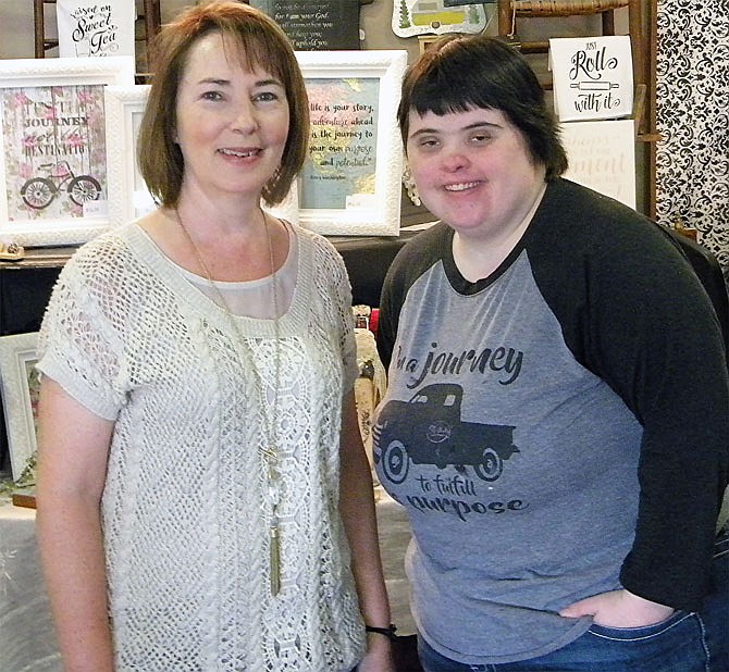 Re-Made for a Purpose co-founder Barbara Reid, left, takes a break with employee Katy Stinson after the announcement her store was named grand marshal of the Fulton Street Fair Parade.