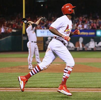 Dexter Fowler of the Cardinals rounds the bases after hitting a three-run home run off Giants pitcher George Kontos during the seventh inning of Friday night's game at Busch Stadium.