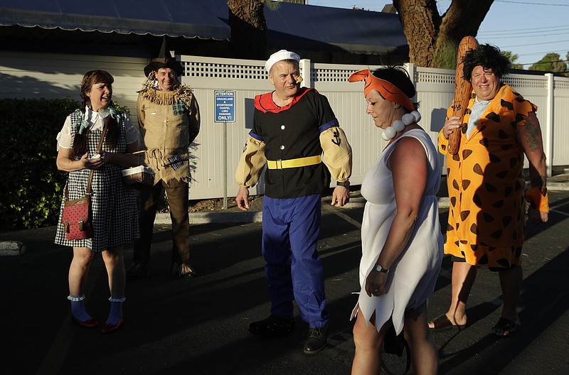 Costumed wedding guests wait for the bride and groom outside of a wedding chapel Tuesday, April 25, 2017, in Las Vegas. The group, from England, were visiting Las Vegas to attend the wedding. 