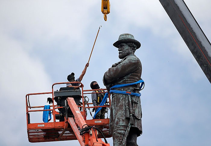 Workers prepare to take down the statue of former Confederate general Robert E. Lee, which stood more than 100 feet tall in Lee Circle in New Orleans.