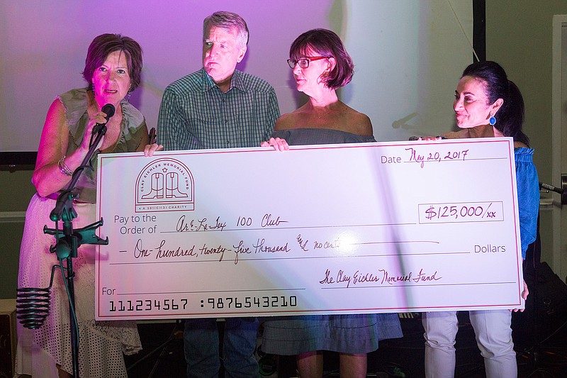 Gail Eichler, Ed Eichler, Debbie Alkire and Barbara Glick present a check for $125,000 from the Clay Eichler Memorial Fund to the ArkLaTex 100 Club on Saturday at North Ridge Country Club. The money was raised from sponsorships and donations received during the Clay's Golf and Guitars event. 