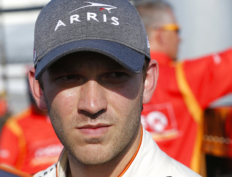 Daniel Suarez talks to a crew member after qualifying for the NASCAR Cup Series auto race at Richmond International Raceway in Richmond, Va., Friday, April 28, 2017. 