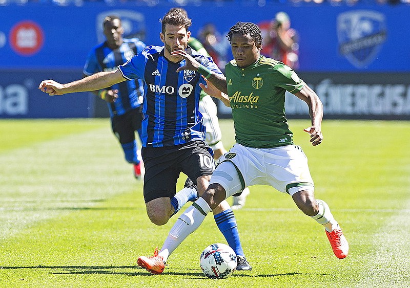 Montreal Impact's Ignacio Piatti, left, and Portland Timbers' Alvas Powell battle for the ball during the first half of an MLS soccer game in Montreal, Saturday, May 20, 2017. (Graham Hughes/The Canadian Press via AP)