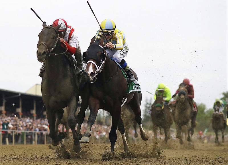 Cloud Computing, left, ridden by Javier Castellano, wins the 142nd Preakness Stakes horse race ahead of Classic Empire, ridden by Julien Leparoux, Saturday, May 20, 2017, at Pimlico Race Course in Baltimore. 