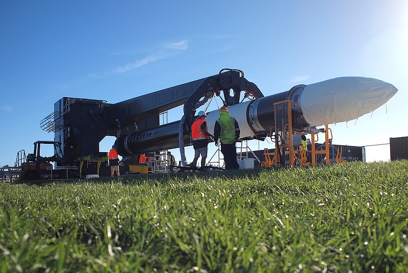 In this May 19, 2017 photo supplied by Rocket Lab, engineers work with the Electron rocket at the launch site on the Mahia Peninsula in the North Island of New Zealand. New Zealand has never had a space program but could soon be launching commercial rockets more often than the United States. That's if the plans of California-based company Rocket Lab work out. Founded by New Zealander Peter Beck, the company was last week given approval by the Federal Aviation Authority to conduct three test launches from a remote peninsula and the first could come as early as Monday. 