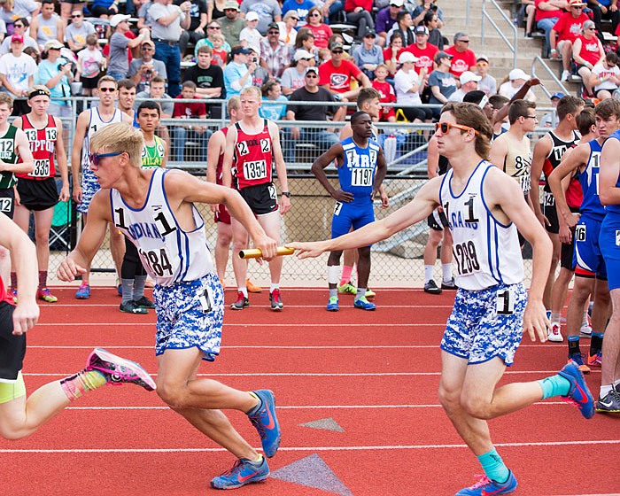 Russellville's Austin Roe hands the baton to teammate Beau Bryant in the Class 2 boys 4x800-meter relay Saturday, May 20, 2017 at Adkins Stadium in Jefferson City.