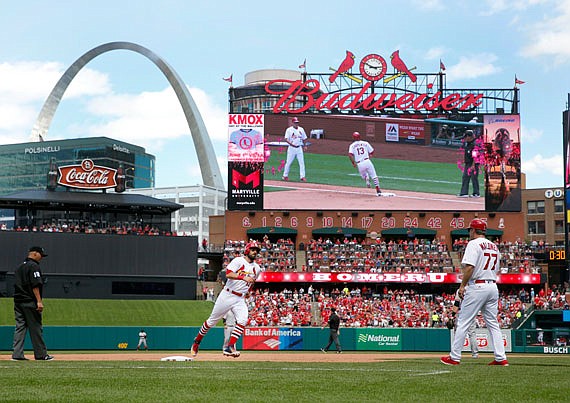 Matt Carpenter rounds the bases after hitting a two-run home run as Cardinals third base coach Chris Maloney (77) watches during the fifth inning of Sunday afternoon's game against the Giants at Busch Stadium.