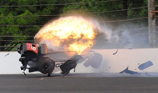 The car driven by Sebastien Bourdais bursts into flames after hitting the wall during qualifications Saturday at Indianapolis Motor Speedway in Indianapolis.