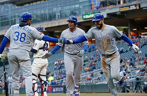 Salvador Perez of the Royals (center) is congratulated by Jorge Bonifacio as he and Eric Hosmer head to the dugout after scoring on Perez's two-run home run during the first inning of the second game of Sunday's doubleheader against the Twins in Minneapolis.