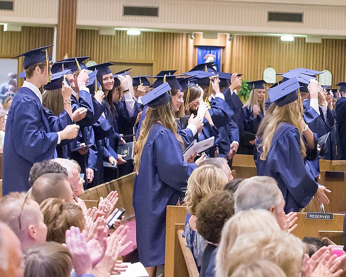 Members of the Helias High School Class of 2017 switch their tassels from one side of their caps to the other during Sunday graduation at St. Joseph Cathedral