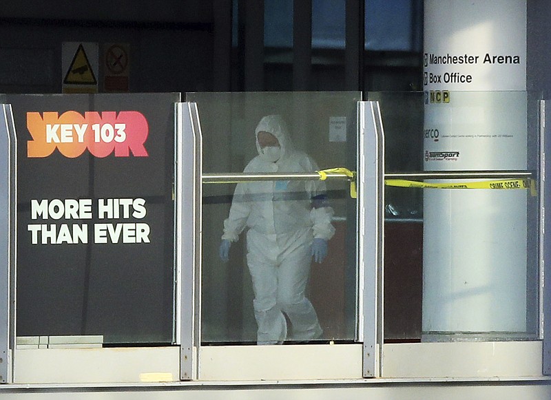 A police forensic investigator walks along a bridge linking Victoria Station with the Manchester Arena Tuesday, May 23, 2017 after an explosion during a concert on Monday, in Manchester, England. Police say they are treating an explosion at an Ariana Grande concert as terrorism. The blast killed over a dozen people.