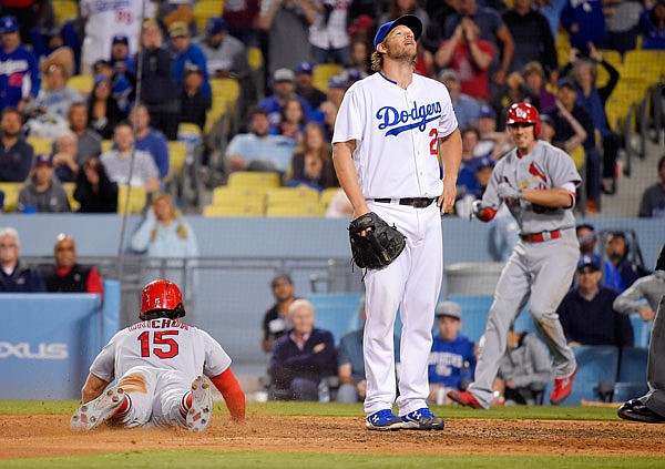 Cardinals left fielder Randal Grichuk scores on a wild pitch by Dodgers starting pitcher Clayton Kershaw as Stephen Piscotty cheers during the ninth inning of Tuesday night's game in Los Angeles.