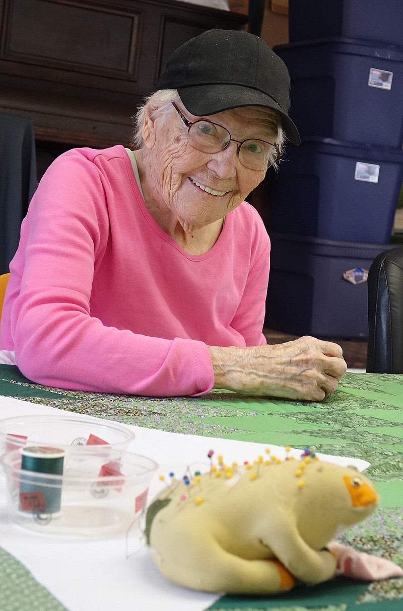 Do you think Oak Grove quilter Dorothy Smith is smiling because she gets to use the Froggie as a pin cushion and he doesn't jump?