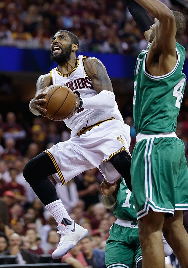 Cavaliers guard Kyrie Irving goes up for a shot against the Celtics' Al Horford during the second half of Game 4 of the Eastern Conference finals Tuesday in Cleveland.