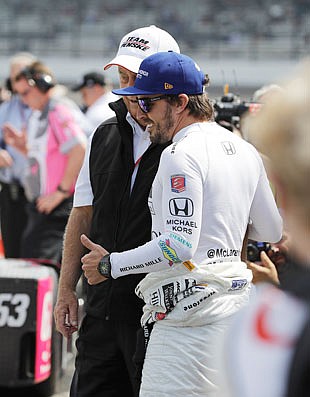 Roger Penske talks with Fernando Alonso during qualifications Saturday for the Indianapolis 500 at Indianapolis Motor Speedway in Indianapolis.