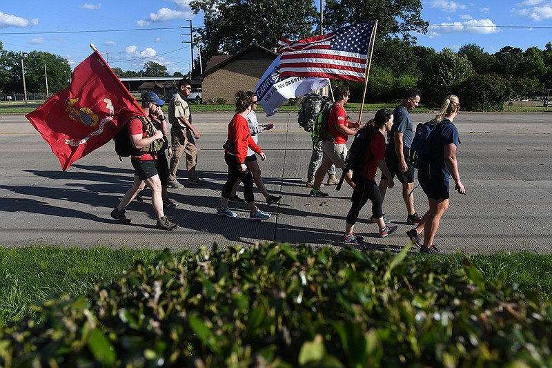 Participants in Carry the Load National Relay make their way Wednesday down U.S. Highway 67 in Texarkana. The group is headed to Dallas.