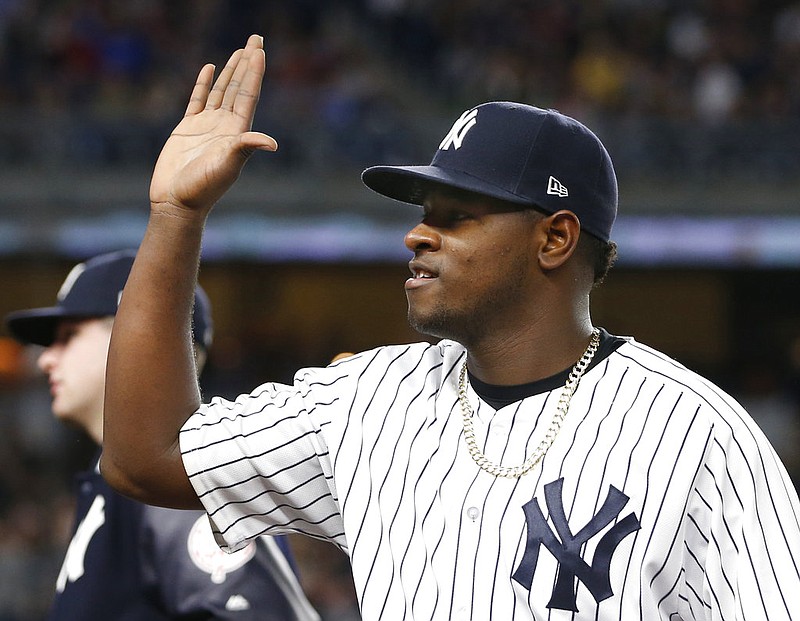 New York Yankees starting pitcher Luis Severino reacts as teammates come out to greet him after he pitched eight innings in the Yankees 3-0 shutout of the Kansas City Royals in a baseball game at Yankee Stadium in New York, Wednesday, May 24, 2017. 