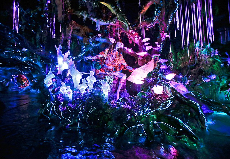  In this April 29, 2017, file photo, the Na'vi Shaman of Songs celebrates with music in Na'vi River Journey ride at Pandora-World of Avatar land attraction in Disney's Animal Kingdom theme park at Walt Disney World in Lake Buena Vista, Fla. The 12-acre land, inspired by the "Avatar" movie, opens in Florida at the end of May at Walt Disney World's Animal Kingdom. It cost a half-billion dollars.