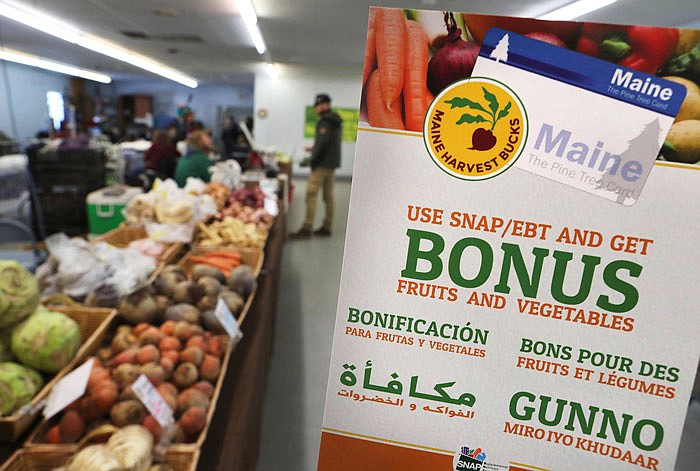 A sign advertises a program that allows food stamp recipients to use their EBT cards to shop at a farmer's market in Topsham, Maine. A proposal to curtail the nation's food stamp program would pinch families struggling to pay for groceries and ripple through other areas of the economy, including supermarkets and discounters.