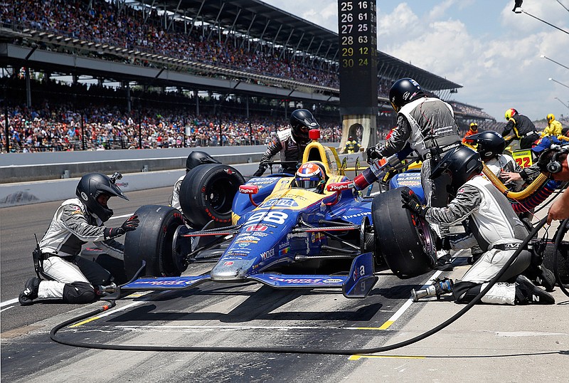 In this May 29, 2016, file photo, the car driven by Alexander Rossi is serviced during a pit stop in the 100th running of the Indianapolis 500 auto race at Indianapolis Motor Speedway in Indianapolis. Putting together the right pit crew can make all the difference on race day. Just ask defending Indianapolis 500 champion Alexander Rossi, who overcame some early race struggles last year and wound up relying on those same guys to help him reach victory lane. 