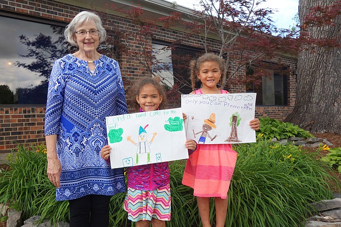 Linda Houston, left, of the Fulton Garden Club helps children at Bush Elementary School like Kamari and Taliyah Travis discover the outdoors through the Blooming Bushes club.